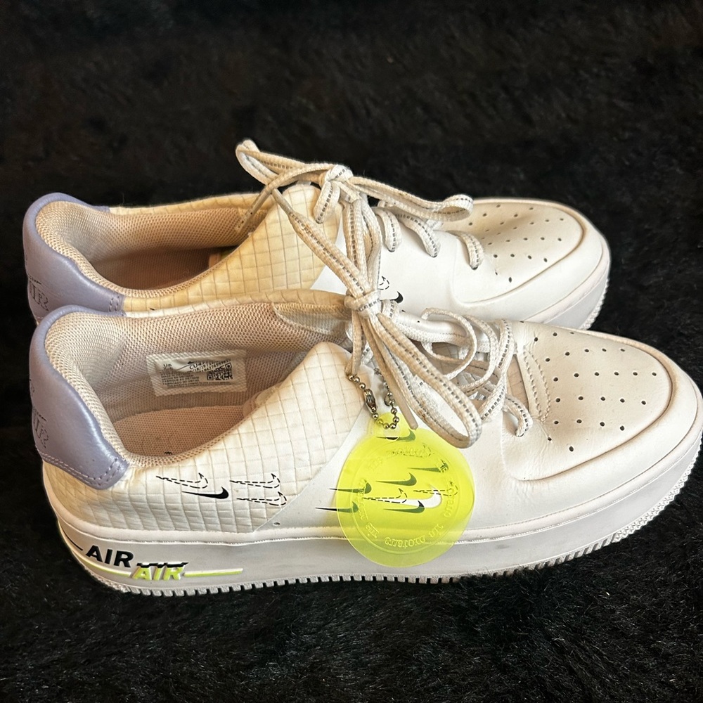 Women’s Nike Air size 8.5 all White with neon green Nike tag. Great condition